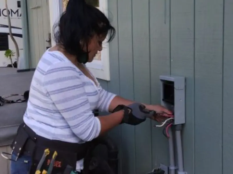 Licensed electrician wiring an exterior subpanel in Fort Irwin