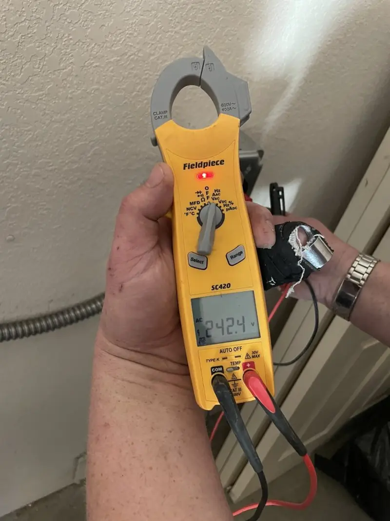 Voltage testing with clamp meter during Electrical Installation Services in Fort Irwin
